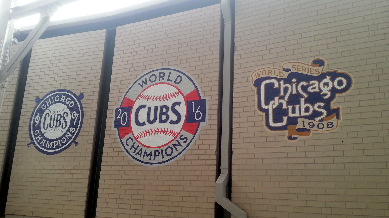 The logos of the World Series winning teams (1907, 1908, 2016), painted in a stairwell in the bleachers.
