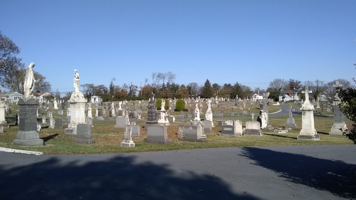 Looking across Holy Cross Cemetery into the northern half, with headstones and statues