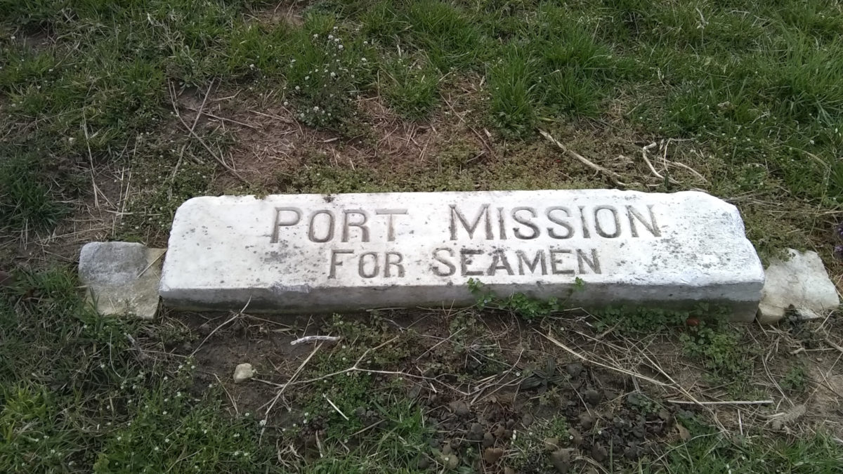 Similar to a railroad tie, this marker reads "Port Mission for Seamen"
