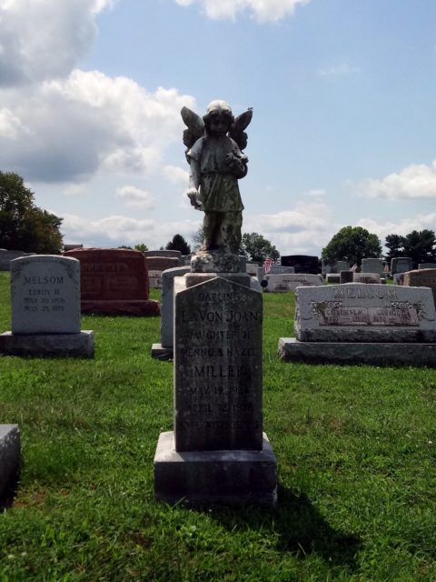A headstone decorated with an angel