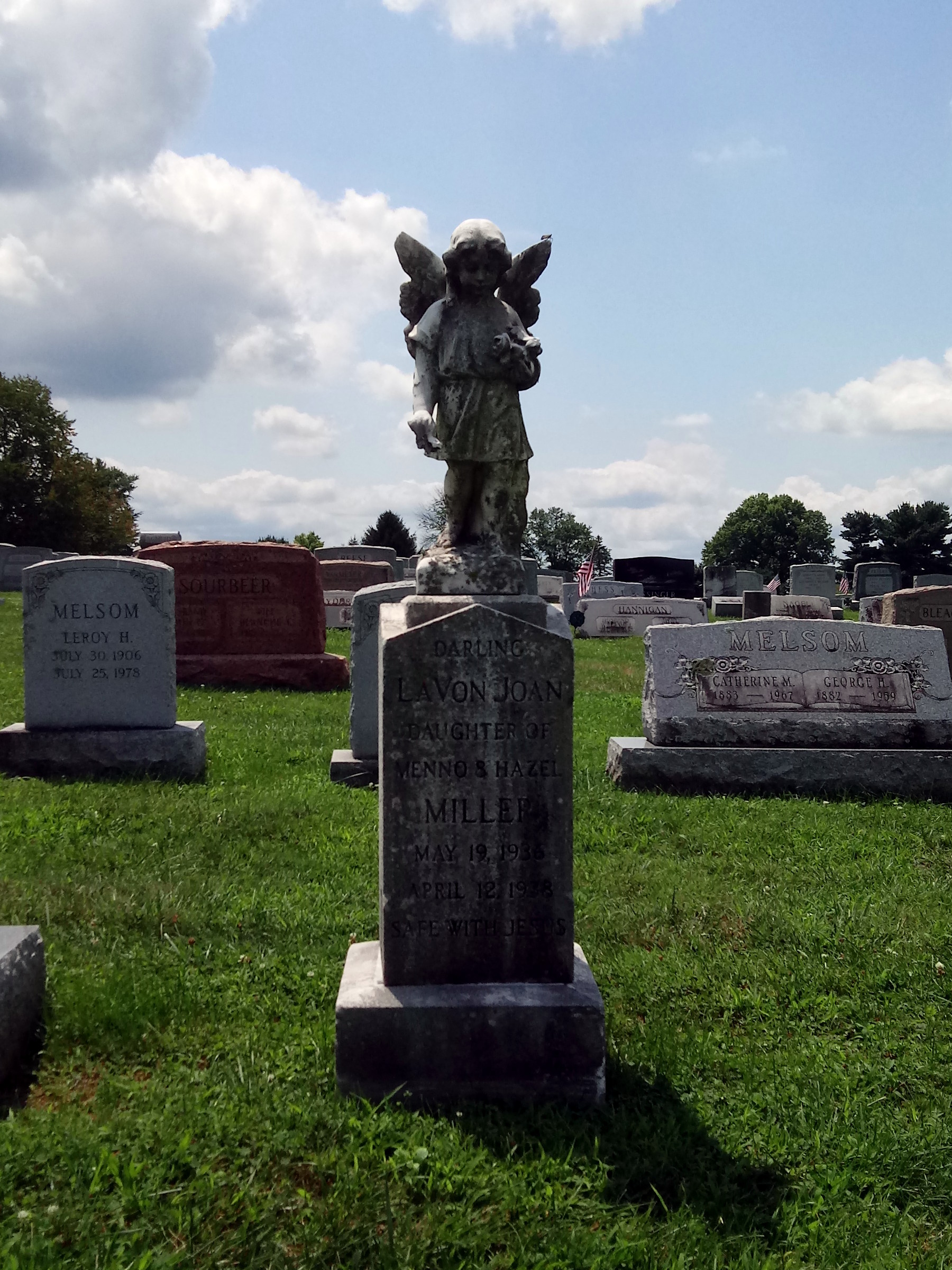 A headstone decorated with an angel