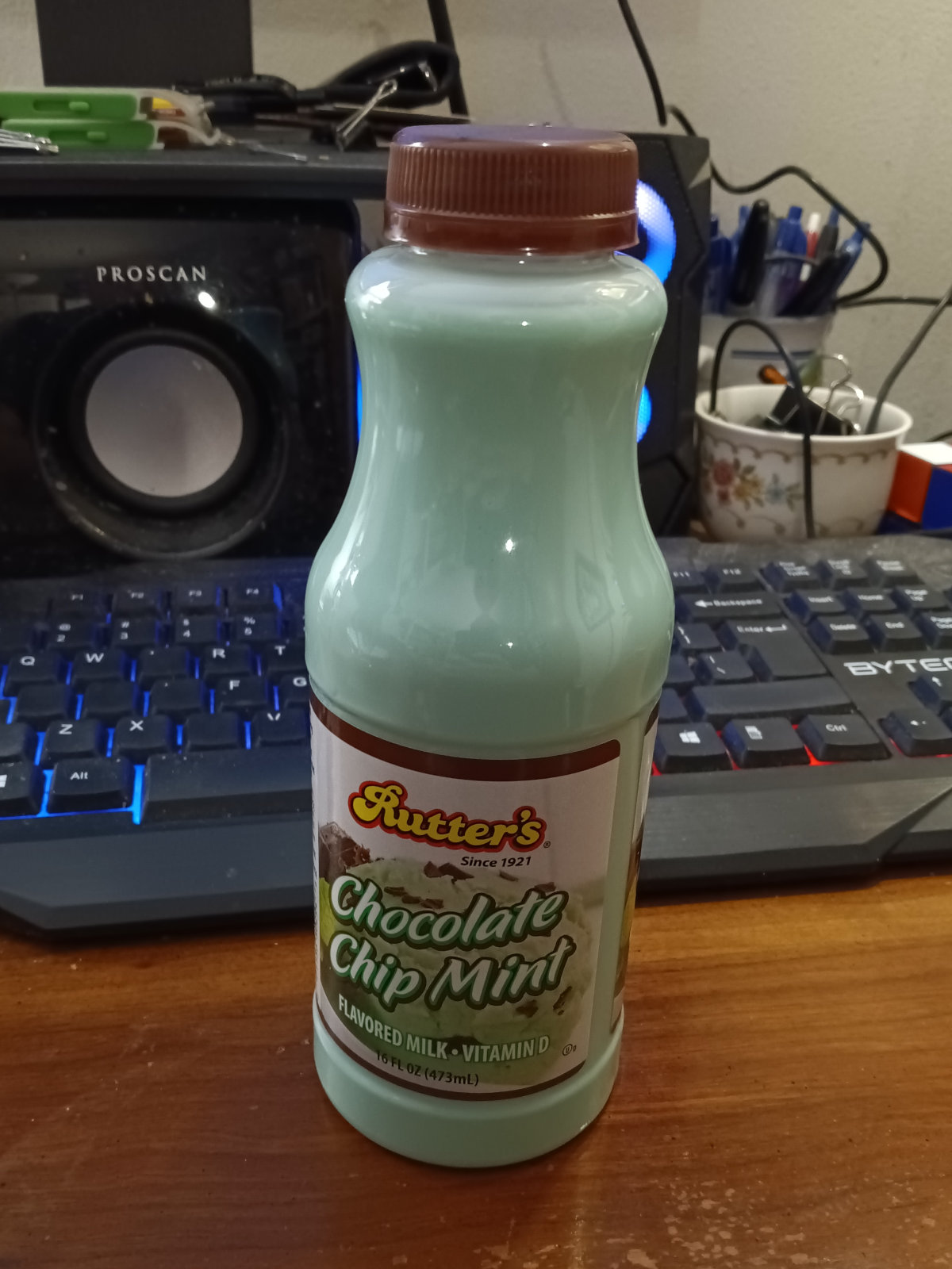 The bottle of Rutter's Chocolate Chip Mint Milk, sitting on my desk at home.  It's a milky green.