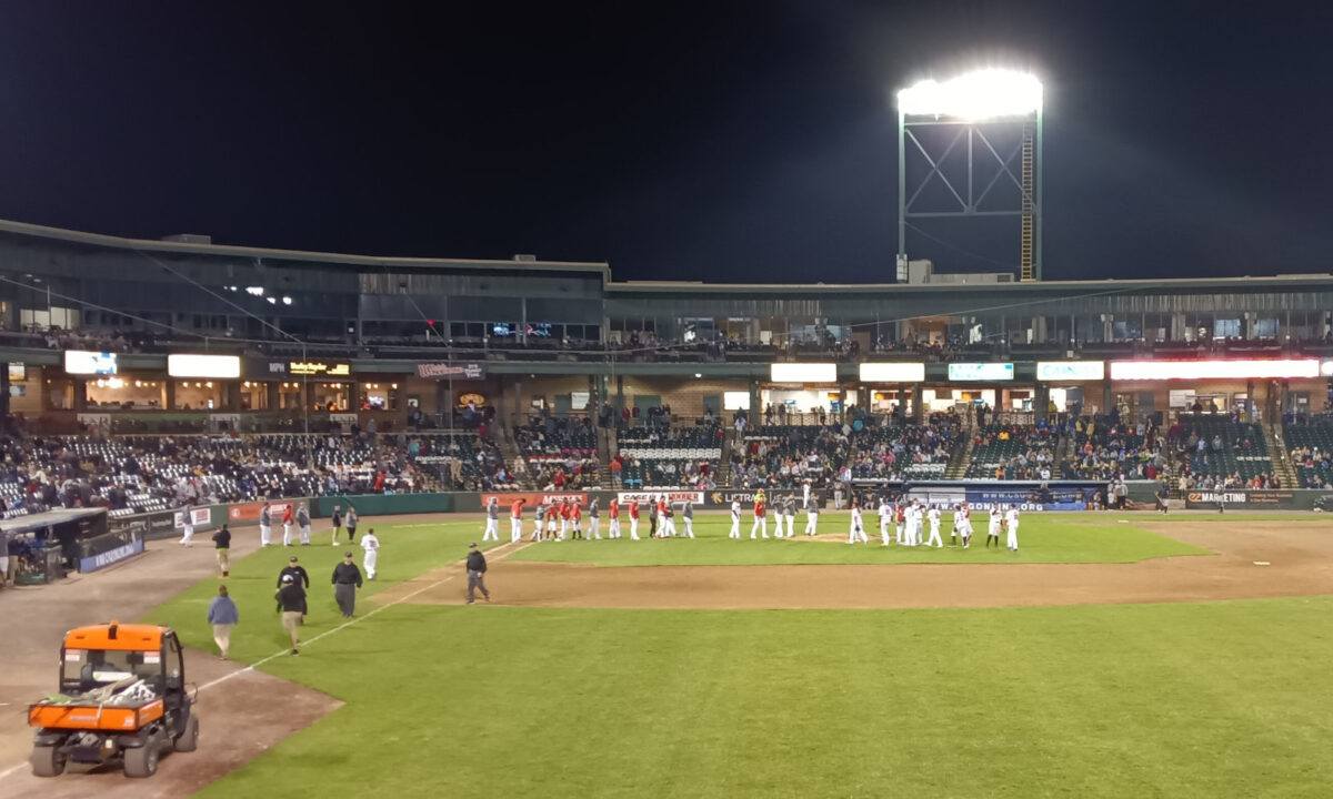 The Barnstormers celebrate their victory on the field while the umpires walk to the clubhouse