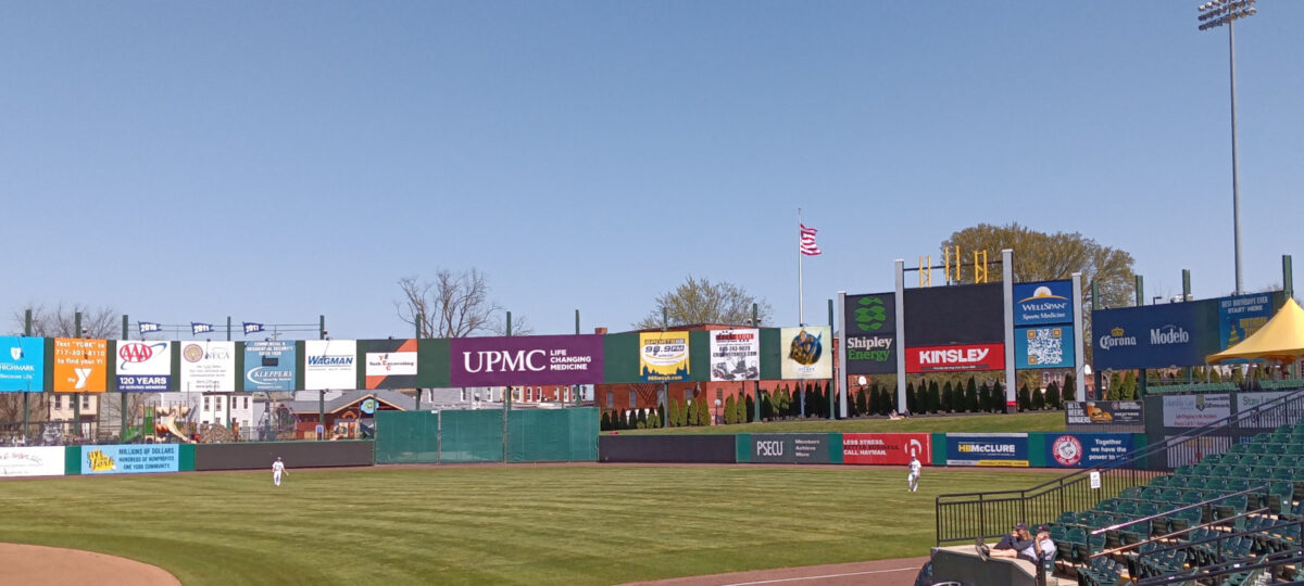View of the outfield wall, showing no name above the scoreboard