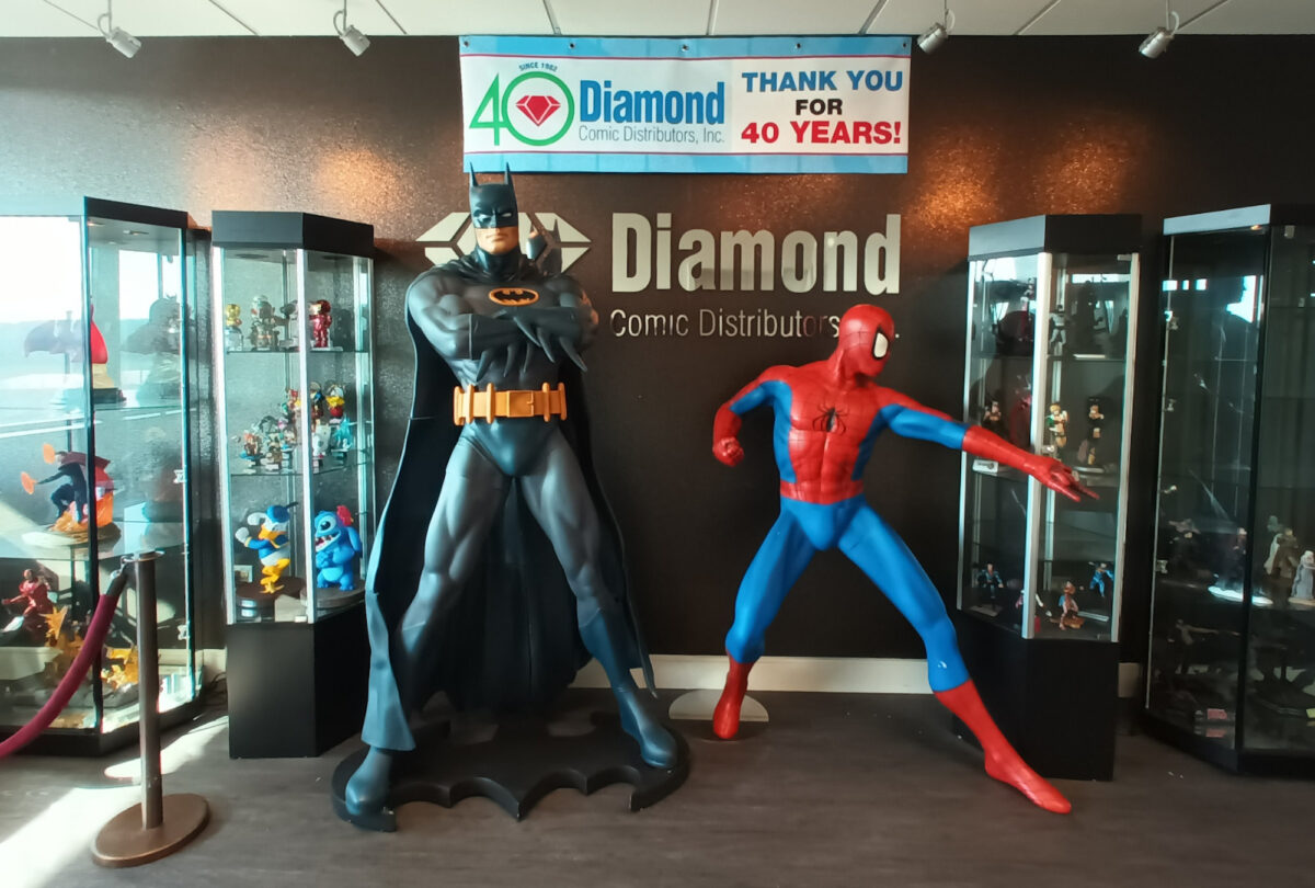 The entrance to Diamond Comic Distributors in 2022, with statues of Batman and Spider-Man greeting you at the elevators