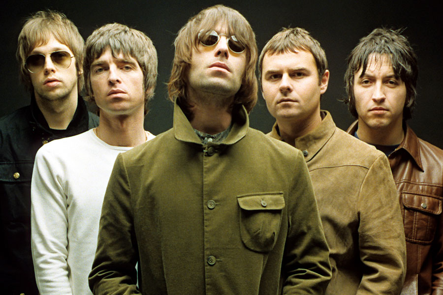 Promo image of Oasis, circa 2000. Left to right, Andy Bell (bass), Noel Gallagher (guitar, vocals), Liam Gallagher (guitar, vocals), Alan White (drums), Gem Archer (guitar)