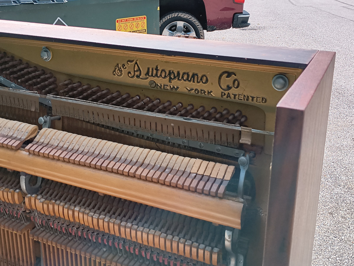 Close-up of the Autopiano Company name inside the piano