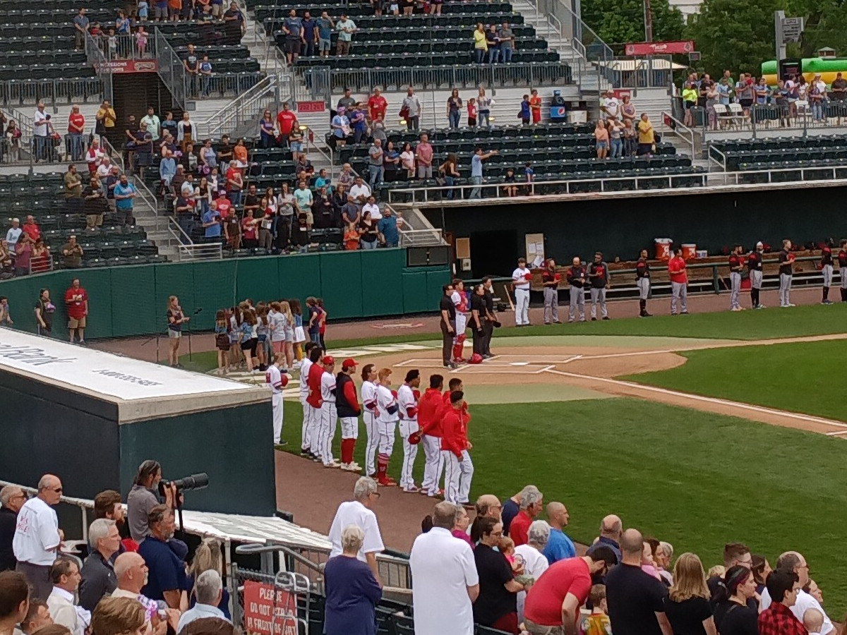 Jen Pawol stands in the center of the umpires during the National Anthem in Harrisburg, May 14, 2022.