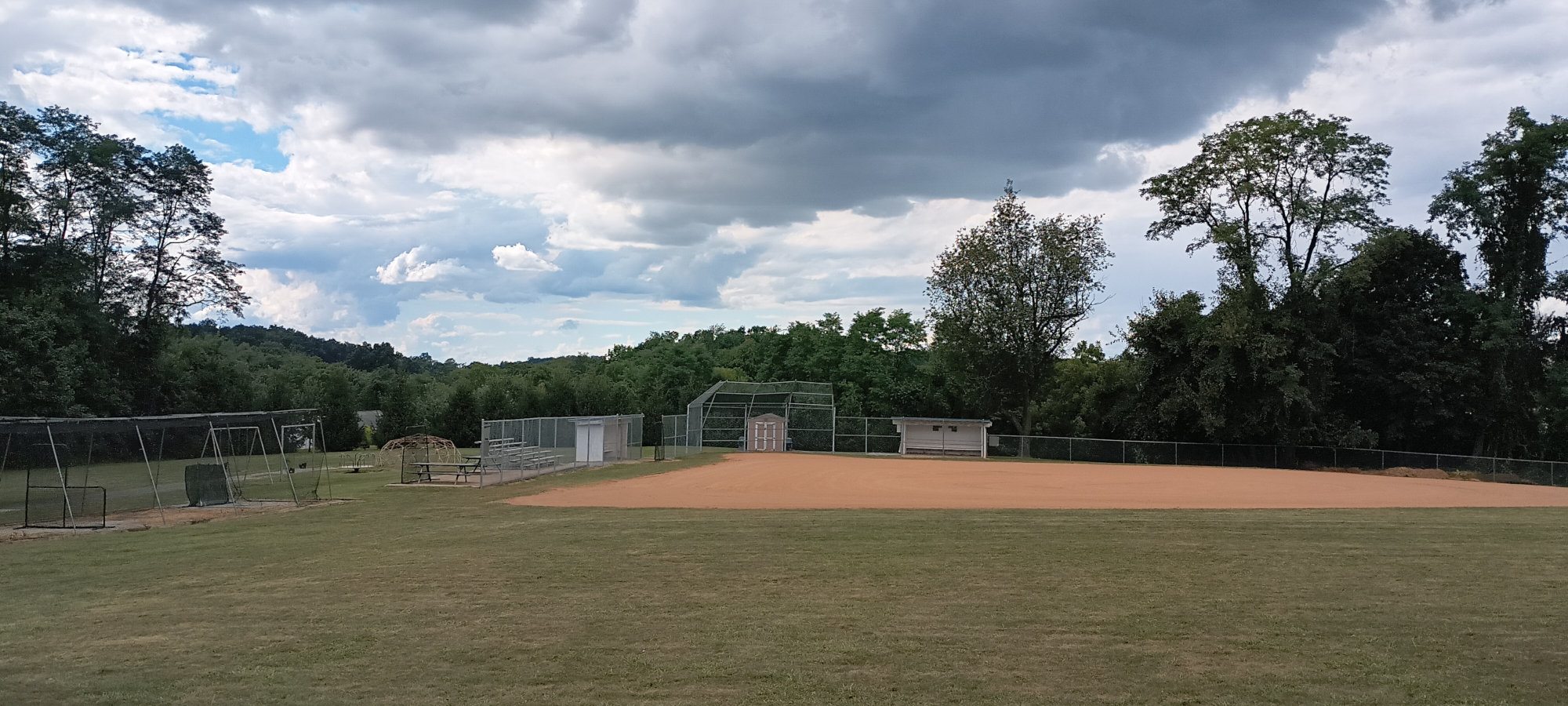 The empty field at the Yoe Ballpark, with ominous clouds looming overhead.