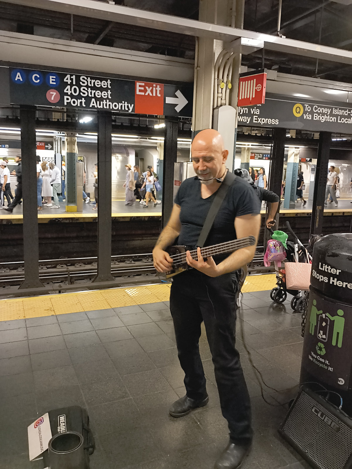 A guitarist on the subway platform at 42nd Street.