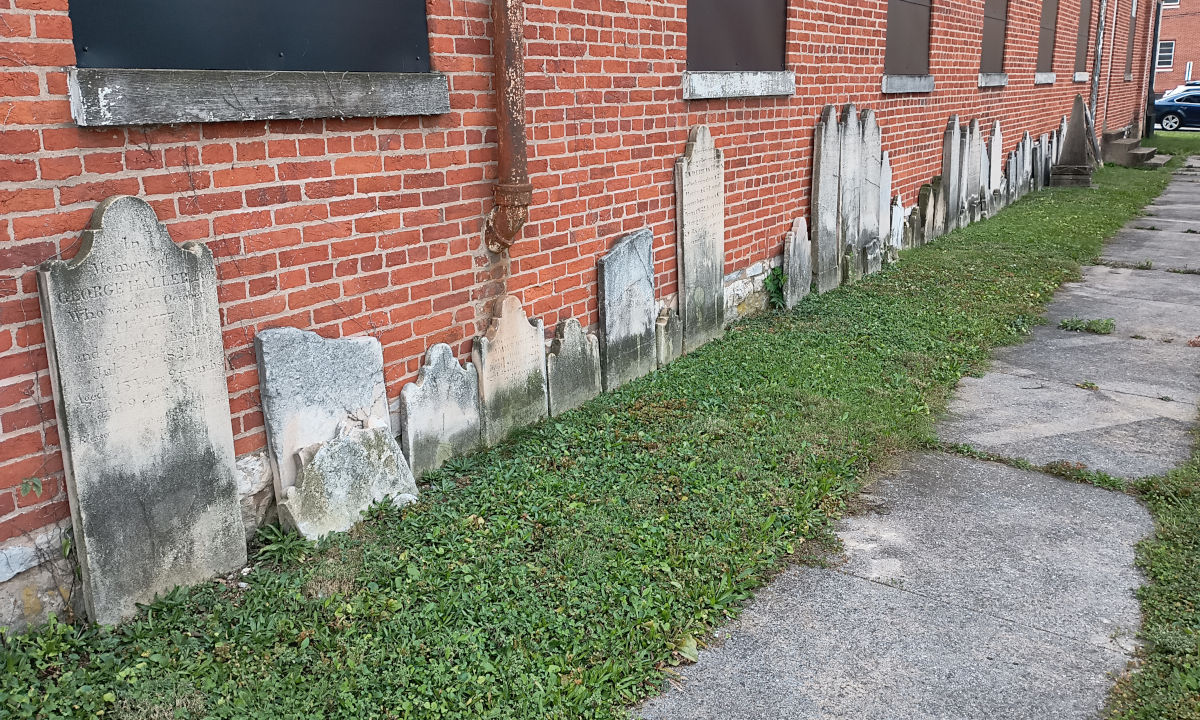 View of the old headstones leaned up against the side of the church