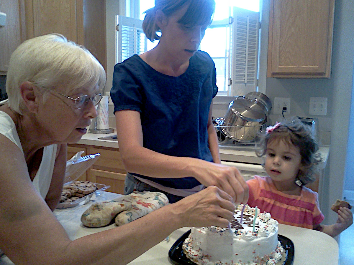 My mom, sister, and niece decorating my sister's birthday cake