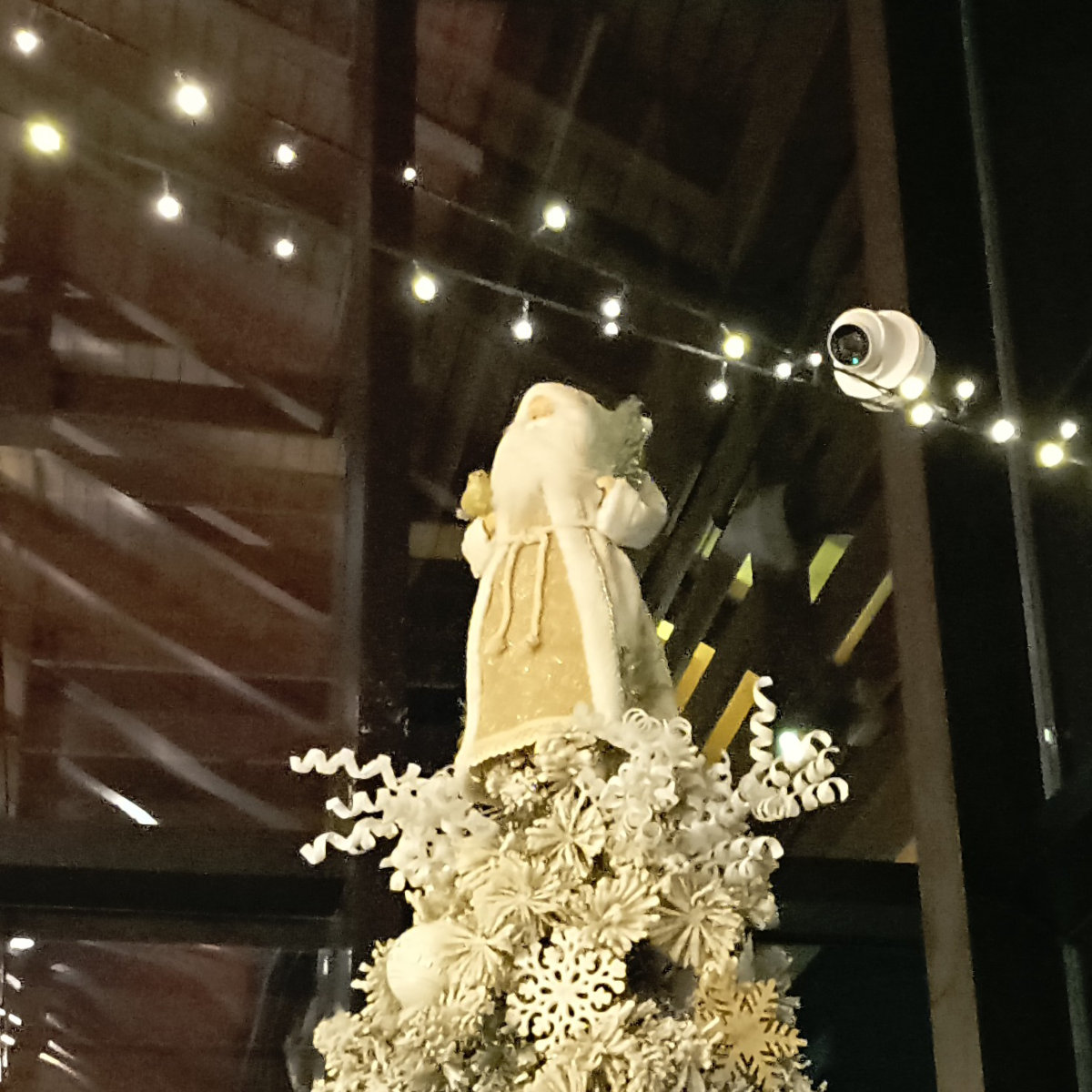 A Santa Claus atop a Christmas tree in a restaurant