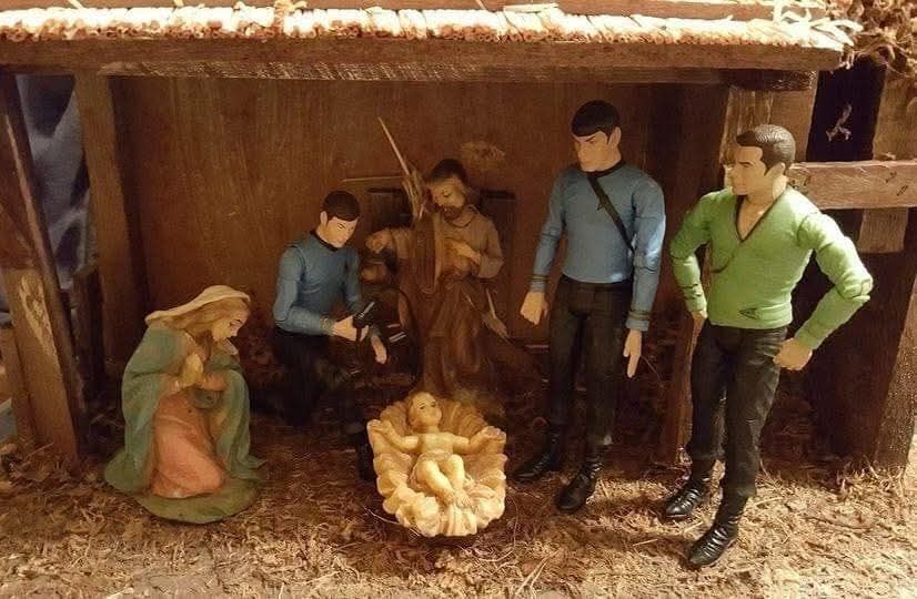 A Nativity scene with figures of Mary, Joseph, Kirk, Spock, and McCoy, all crowded around the creche