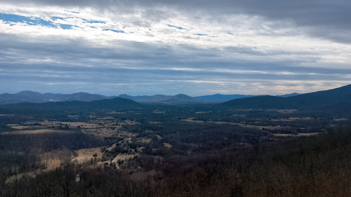 Layered clouds over Rockfish Gap, with some distant mountains in sunlight and closer mountains in shadow