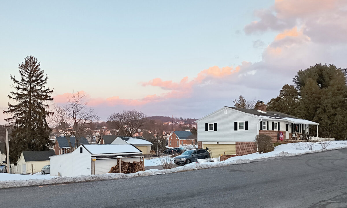 Pink clouds at the horizon beyond the hills
